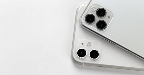 A close-up of two silver iPhones with dual and triple rear cameras, showcasing their modern design on a white background.